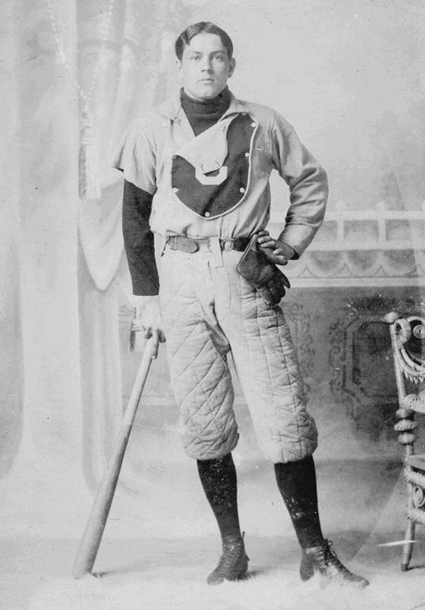 Baseball history photo:  Arthur Van Winkler, Centre College baseball player, 1891. Note the primitive fielder's glove, devoid of padding.  Even by 1891, gloves for players other than the catcher were slowly developing.  Winkler may have been a pitcher as is evidence to the fact that his right uniform sleeve has been tailored into a short sleeve.  The bat he is leaning on shows only small taper from the 2&frac12; inch barrel to the handle which was the standard in the 19th century.  Winkler's baseball pants are also fully padded as seen by the quilt stitched pattern.  Ads for sliding pads first appeared in the 1887 Spalding's Official Base Ball Guide as Morton's Patent Sliding Pad.  This was a quilted piece of material that was strapped to the player's leg, on top of his pants, covering the hip and thigh just above the knee.  It was available in chamois and canvas and according to the ad, Its use increases a player's confidence, and renders the act of sliding free from danger. The following year Spalding offered baseball pants with the padding stitched into the game pants, at an extra cost, as well as the Morton sliding pad.  Click photo to return to previous page.