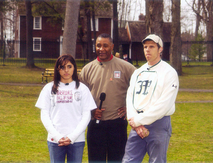 April 26, 2005 - Cooper Park, Cooperstown, NY.  Tuyaymya Osuna, student from San Diego, CA, Hall of Fame baseball player Ozzie Smith and Eric Miklich, 19c Base Ball, NY Mutuals and Old Bethpage Village Restoration, shown during a brief time out while filming &ldquo;Discovering Our American Sprit,&rdquo; sponsored by Ball State University and the Baseball Hall of Fame.  Both live programs of this Electronic Field Trip were seen by an estimated 17 million grade school students in North America.  Miklich explained and demonstrated the history of the pitcher including the evolution of pitching deliveries from 1860&ndash;1887 during both of his eight minute segments. Click photo to return to previous page.