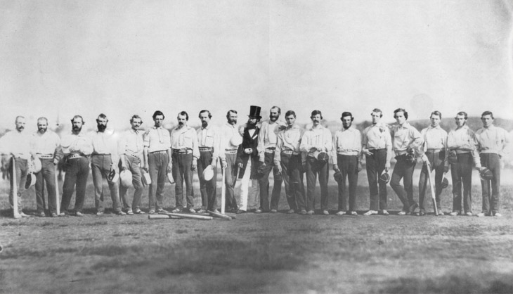 Baseball history photo: This photograph, taken by Brooklyn photographer Charles H. Williamson, depicts the Knickerbocker Base Ball Club and the Excelsior Base Ball Club in one of the earliest known team photos and perhaps the first image on a baseball field.  It was taken on September 3, 1859, at Elysian Fields, Hoboken, New Jersey.  Some of the players are as follows; Knickerbockers&mdash;James Whtye Davis (second from left), Charles Schuyler De Bost (third from left) and Harry Wright (sixth from the left).  The umpire is Dr. J.B Jones (middle in overcoat and hat) and the Excelsiors are&mdash;Henry D. Polhemus (Jones's left), John Holder (Sixth from right), Edwin Russell (fifth from right) and Thomas Reynolds (far right). Click photo to return to previous page.
