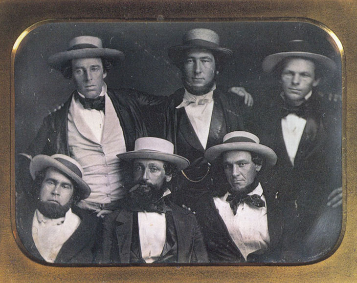 Baseball history photo: A photo purported to be of the New York Knickerbockers Baseball Club circa 1847. The only positively identified member of the Knickerbockers Base Ball Club in this photo is Alexander Cartwright (top center). Harold Peterson, author of &ldquo;The Man Who Invented Baseball&rdquo;, has conjectured that the clean-shaven fellow at the top left may be Cartwright's younger brother, Alfred. Indeed, the two young men are similar in appearance and each has his arm around the other's shoulder. (According to club records, Alfred was never a member of the Knickerbocker Base Ball Club.) Some have proposed that the individual at lower left is Duncan Curry, first Knickerbocker club president. This identification is based solely on a photo of a much older Curry on p. 54 of Albert Spalding's &ldquo;America's National Game.&rdquo; This identification is tenuous at best. The cigar-smoking chap at lower center bears some resemblance to Daniel &ldquo;Doc&rdquo; Adams, though the conjecture is by no means definitive. In short, though it is not unlikely that this image is of six members of the Knickerbockers, it is by no means definitively a Knickerbocker team photo.  Click photo to return to previous page.