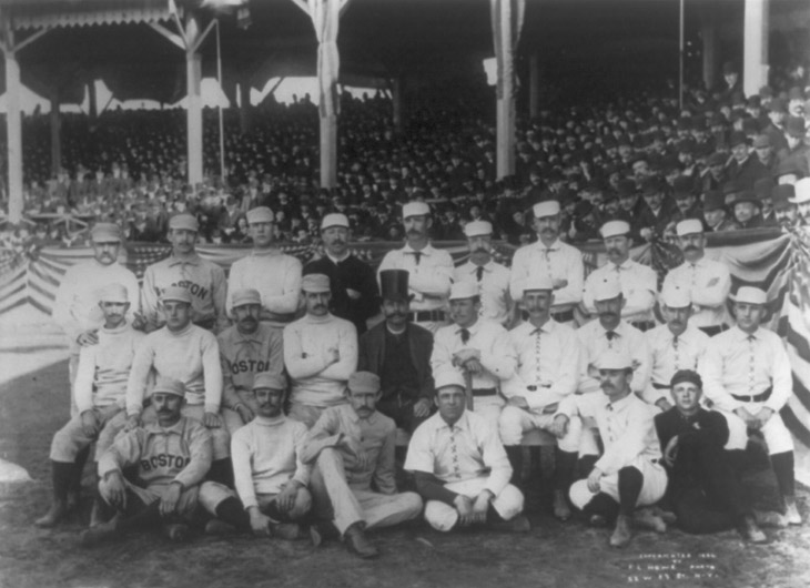 Baseball history photo: 1886 Boston/New York team photo. Charles &ldquo;Old Hoss&rdquo; Radbourn is first from left standing with middle finger covertly extended. Click photo to return to previous page.